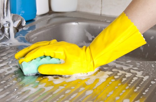 Local cleaners working in a Hammersmith rental property kitchen and living area