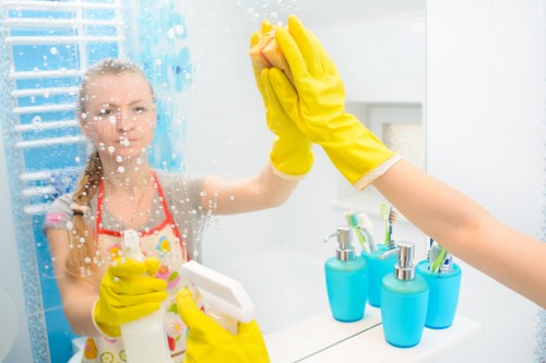 Domestic cleaner tidying a kitchen in Hammersmith